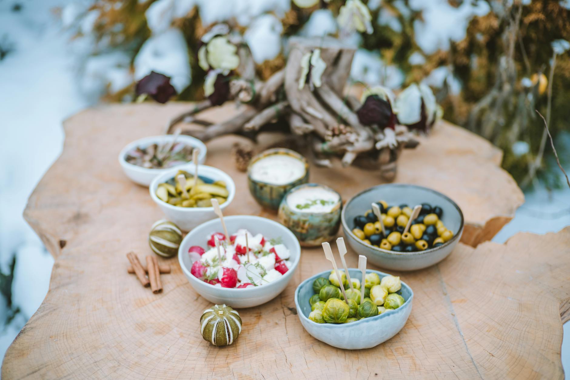Bowl of creamy viral pickle dip topped with chopped dill pickles and herbs, surrounded by potato chips for dipping