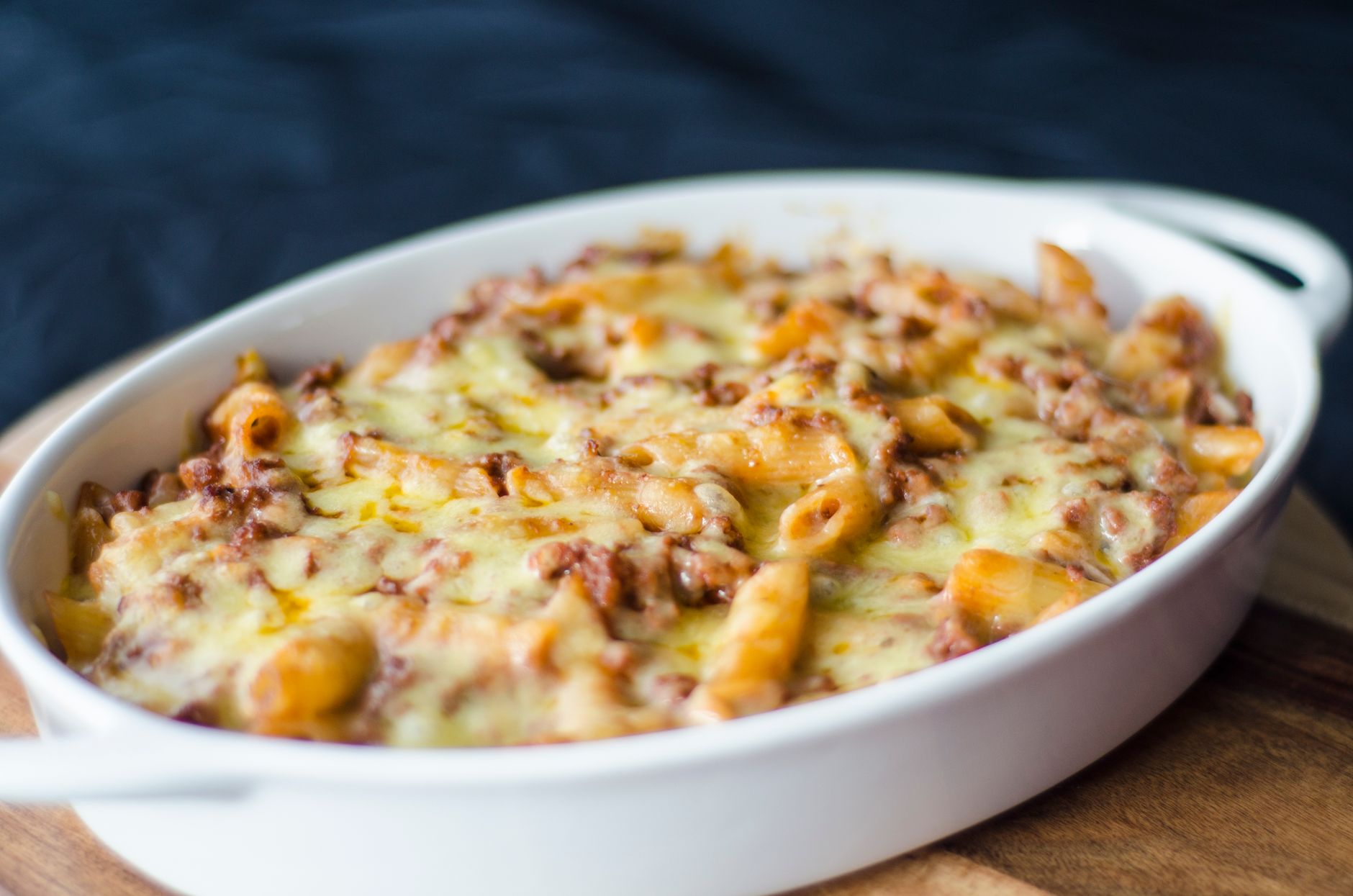 Baked stuffed and layered meatballs in a casserole dish with melted cheese and tomato sauce