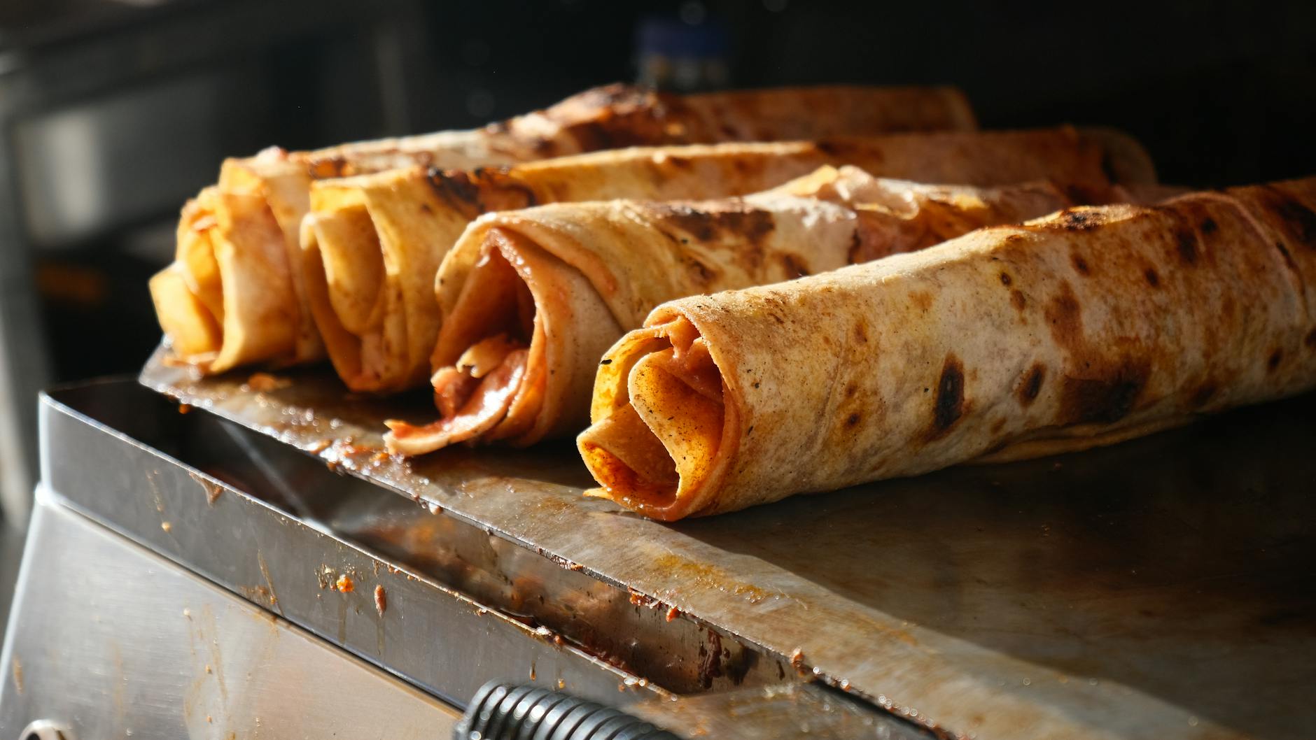 sliced parchment doner kebab chicken wrapped in flatbread with lettuce and tomatoes