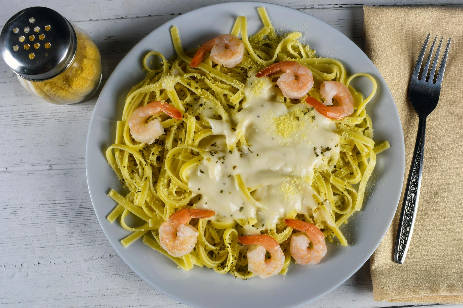 Creamy garlic butter shrimp pasta with parmesan, parsley, and tender shrimp in a rich sauce
