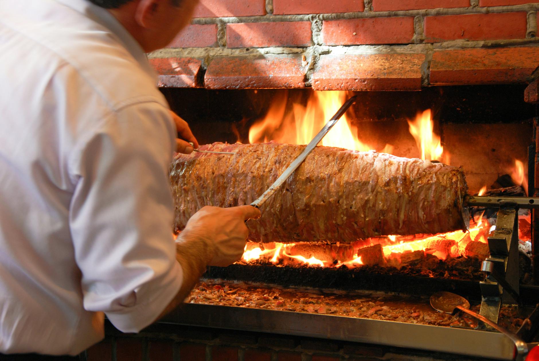 sliced parchment doner kebab with salad and pita on a tray
