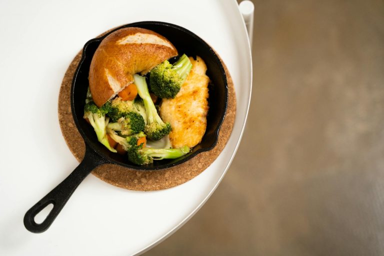 Juicy chicken breasts in a skillet with lemon herb pan sauce and fresh parsley