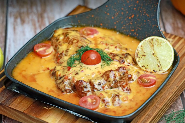 Chicken in a creamy tomato sauce in a skillet