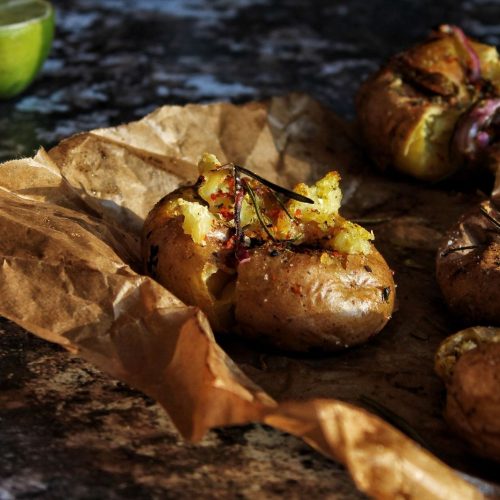 Crispy baked potatoes on brown paper