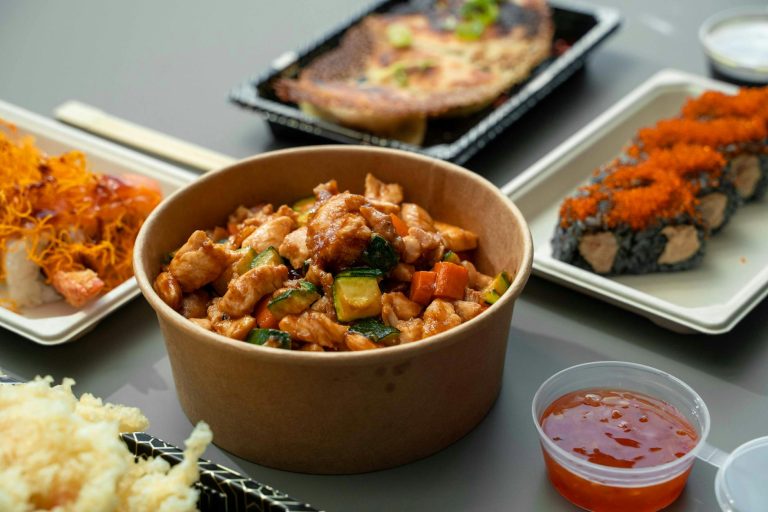 skillet filled with teriyaki chicken stir fry with broccoli and peppers over rice
