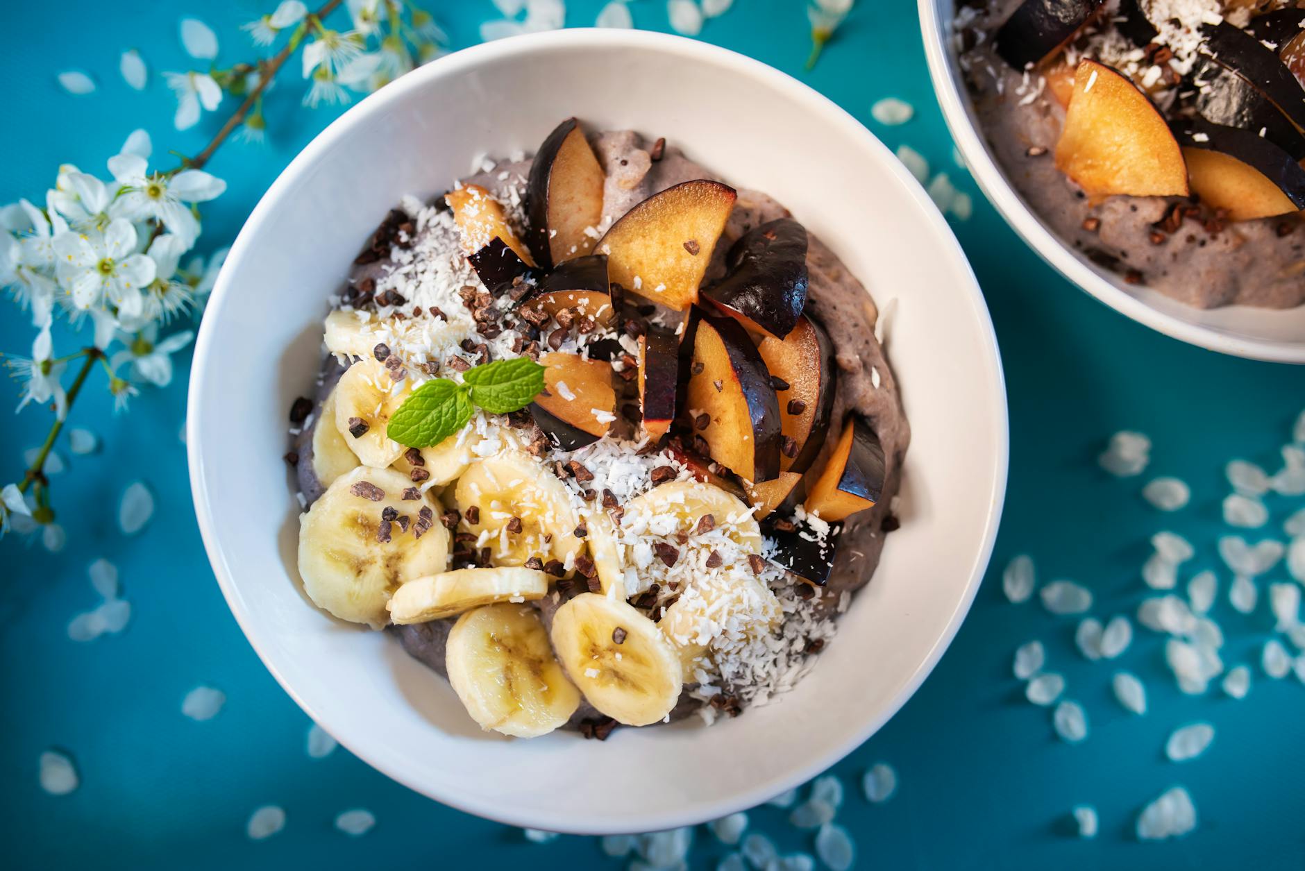 High-protein ube and coconut breakfast bowl topped with mango, blueberries, chia seeds, and toasted coconut