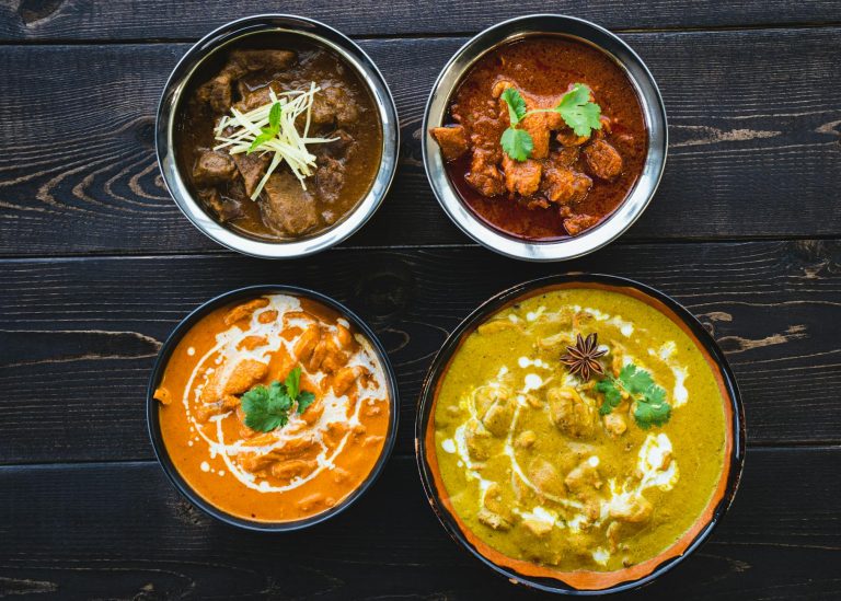 Authentic chicken tikka masala served over basmati rice with naan and cilantro garnish