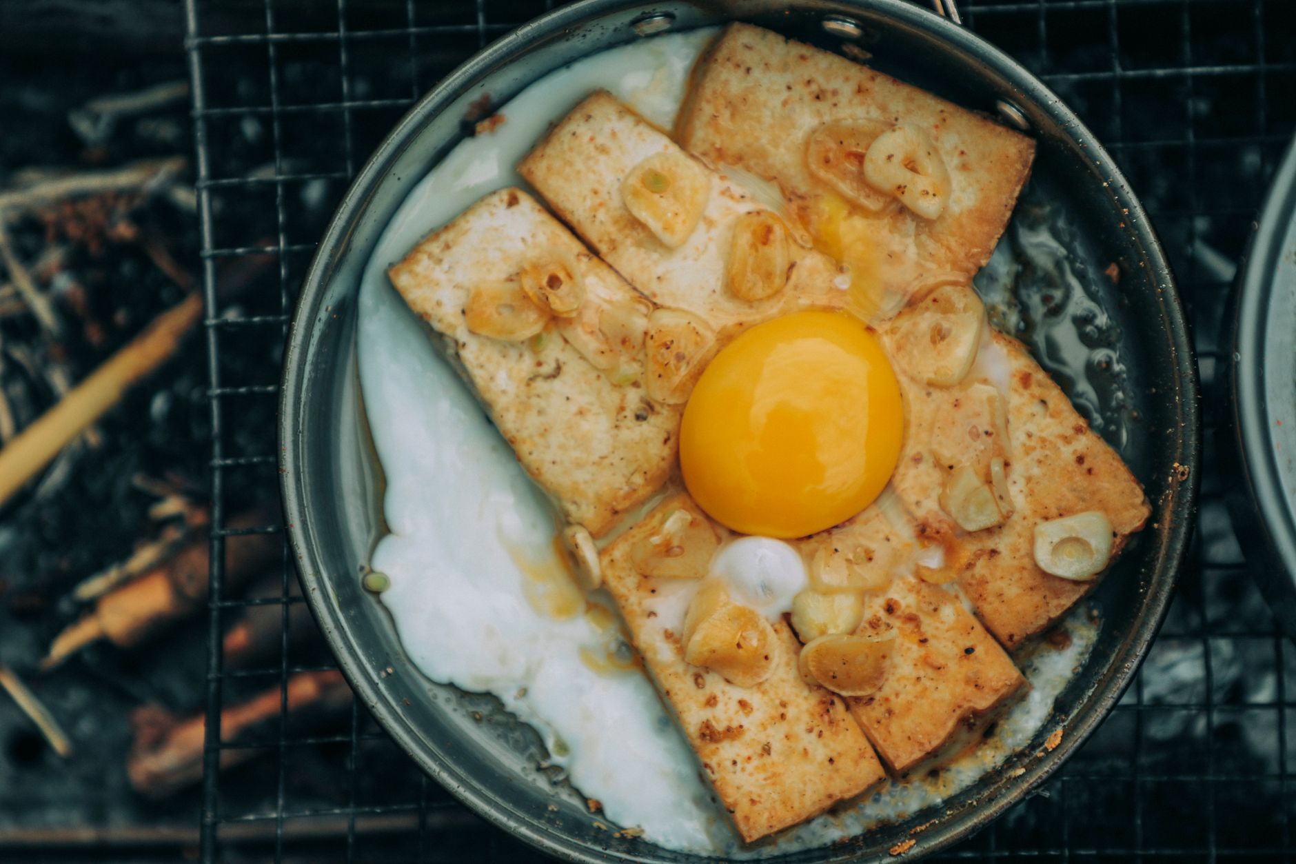 Crispy honey garlic tofu coated in glossy sauce with sesame seeds and green onions
