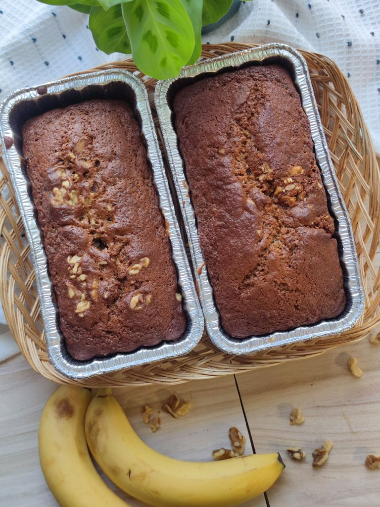 Easy vegan banana bread loaves made in one bowl, topped with chopped walnuts and sliced bananas