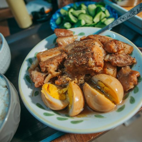 Filipino pork adobo with soy-vinegar sauce, boiled eggs, and white rice