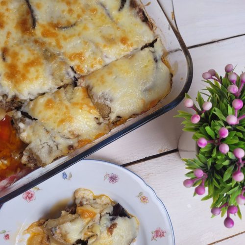 baked traditional Greek moussaka in a casserole dish with golden béchamel top