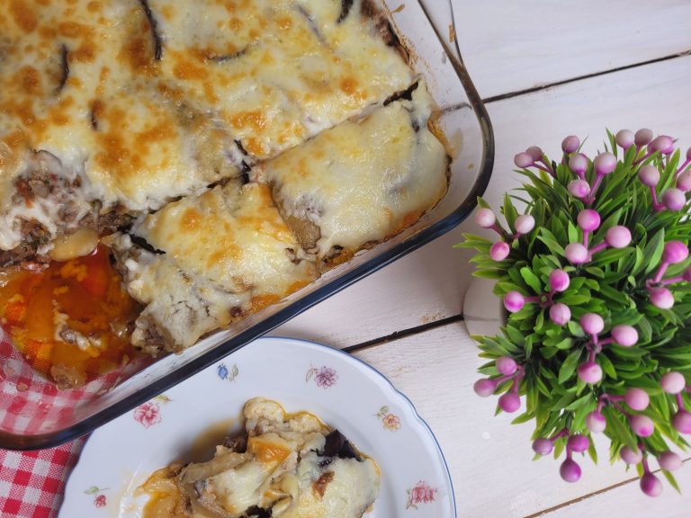 baked traditional Greek moussaka in a casserole dish with golden béchamel top