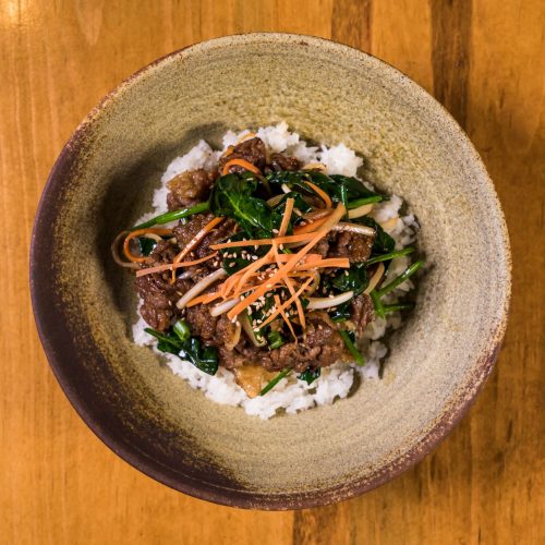 Korean bulgogi beef bowl with rice, spinach, and carrot