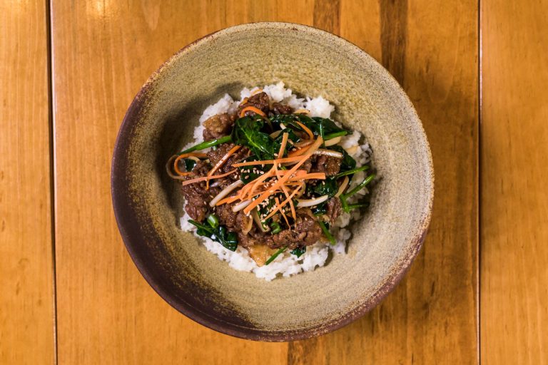 korean bulgogi beef bowl with rice, veggies, and fried egg