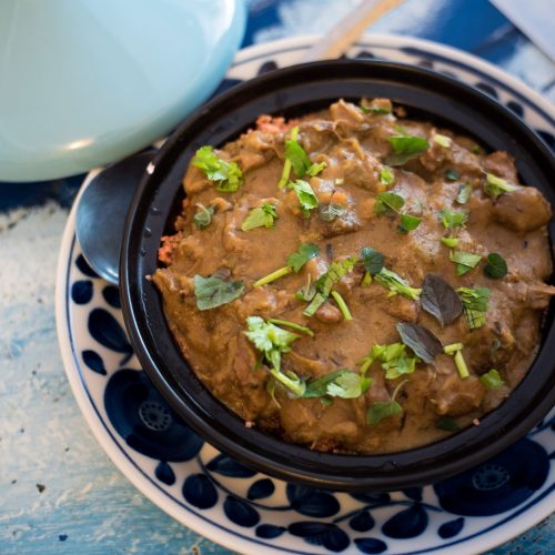 Moroccan lamb tagine with prunes and almonds in a rustic dish