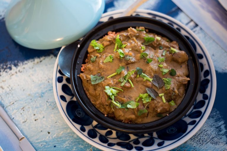 Moroccan lamb tagine with prunes and almonds in a rustic dish