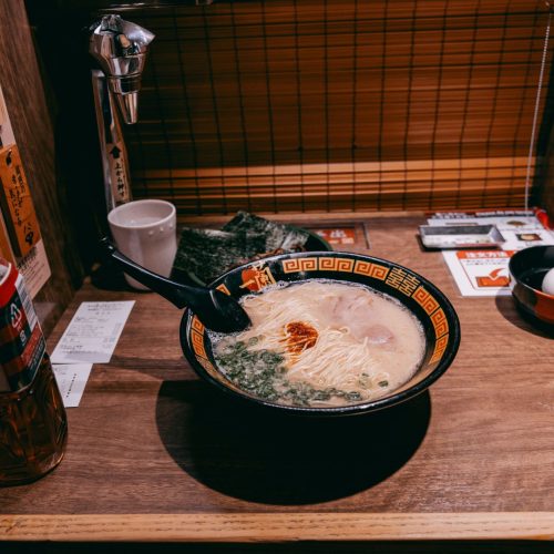 Creamy authentic tonkotsu ramen broth served in a bowl with noodles and toppings