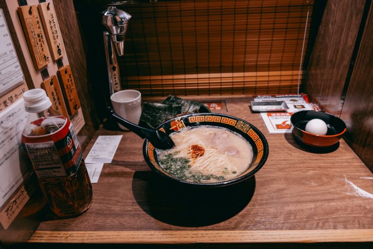 Creamy authentic tonkotsu ramen broth served in a bowl with noodles and toppings