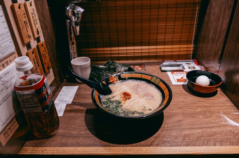 Creamy authentic tonkotsu ramen broth served in a bowl with noodles and toppings