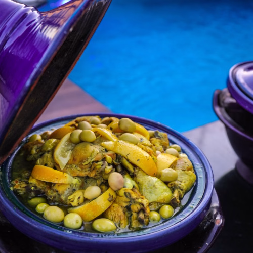 Chicken tagine with preserved lemon and olives in a purple pot