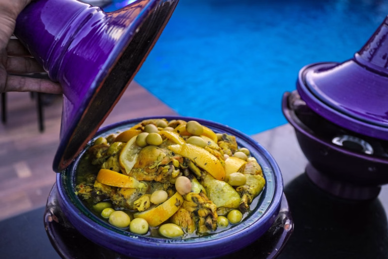 Chicken tagine with preserved lemon and olives in a purple pot